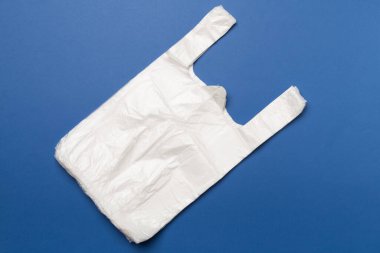 Plastic bag on color background, top view