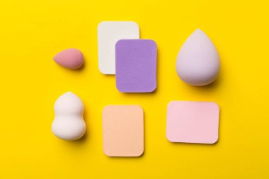 Beauty blenders on color background, top view