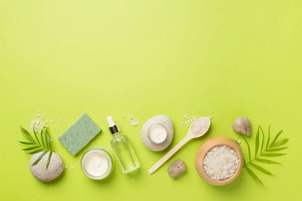 Composition with spa products on color background, top view.