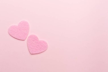 Felt hearts on color background, top view