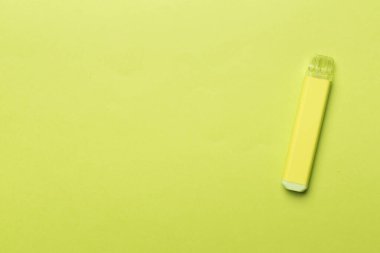 Disposable electronic cigarette on color background, top view
