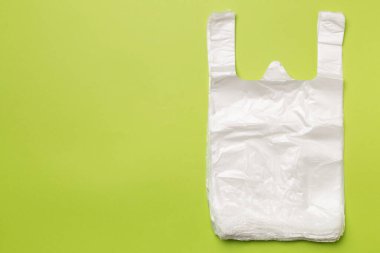 Plastic bag on color background, top view.