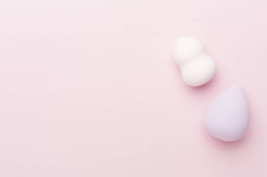Beauty blenders on color background, top view