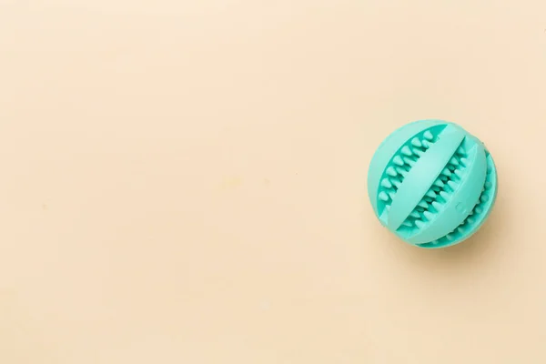 Blue ball toy for dogs on color background