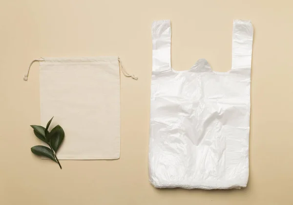 Plastic and fabric bag on color background, top view. Biodegradable products concept