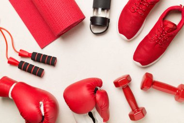 Red sport equipment on concrete background, top view clipart