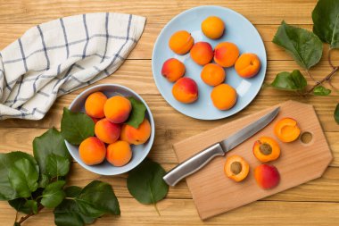 Composition with ripe apricots on wooden background, top view.