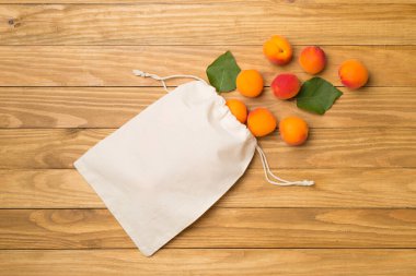 Composition with ripe apricots on wooden background, top view.