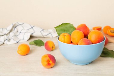 Composition with ripe apricots on wooden table.