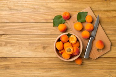 Composition with ripe apricots on wooden background, top view.