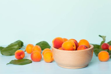 Composition with ripe apricots on wooden table.