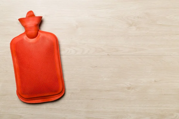 Rubber water warmer bag on wooden background