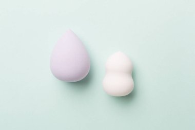 Beauty blenders on color background, top view