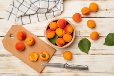 Composition with ripe apricots on wooden background, top view.
