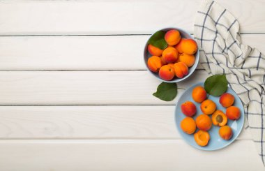 Composition with ripe apricots on wooden background, top view.