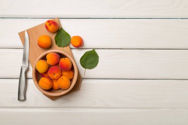 Composition with ripe apricots on wooden background, top view.