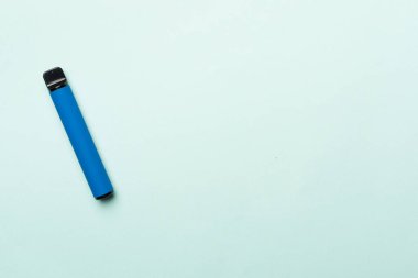 Disposable electronic cigarette on color background, top view