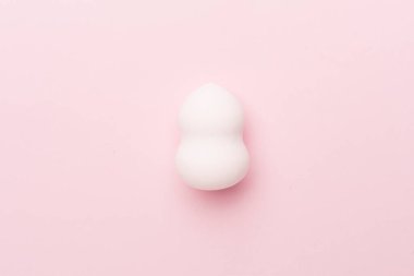 Beauty blender on color background, top view