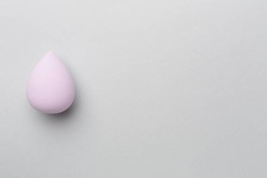 Beauty blender on color background, top view