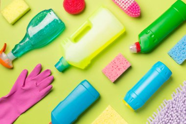 Renk arkaplanı ve üst görünümde birçok farklı ev temizleme ürünleri.