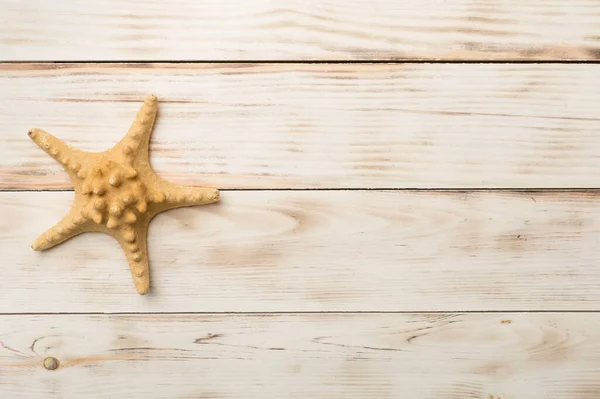 stock image Starfish on wooden background, top view.