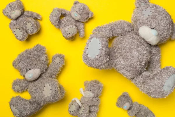 Cute teddy bears on color background, top view