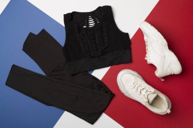 Renkli arka planda spor kıyafetleri olan düz konum, üst görünüm.