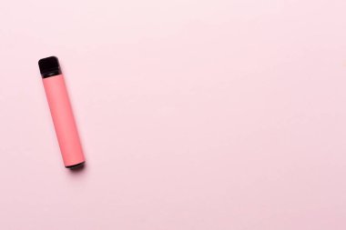 Disposable electronic cigarette on color background, top view
