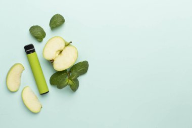 Disposable electronic cigarettes with fruits on color background, top view