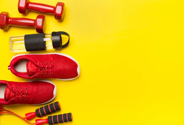 stock image Red sport equipment on color background, top view