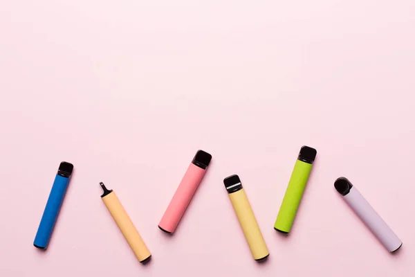 Disposable Electronic Cigarettes Color Background Top View — Fotografia de Stock