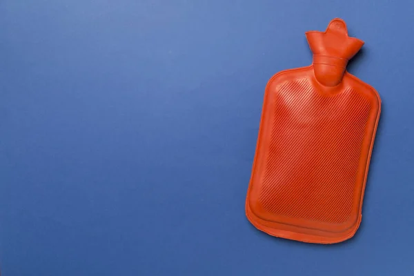 Rubber water warmer bag on color background