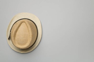 Straw hat on color background, top view.