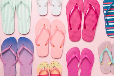 Renk arkaplanı ve üst görünümde birçok parlak parmak arası terlik