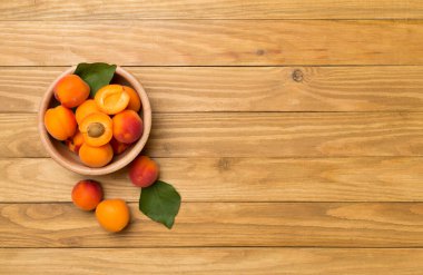 Composition with ripe apricots on wooden background, top view.