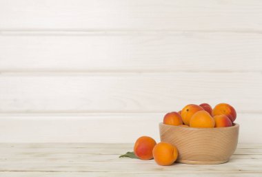 Composition with ripe apricots on wooden background, top view.
