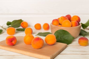 Composition with ripe apricots on wooden background, top view.