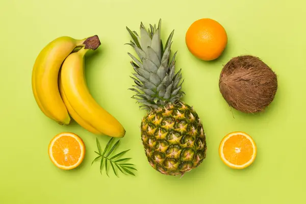 Stock image Fresh tropical fruits on color background, top view