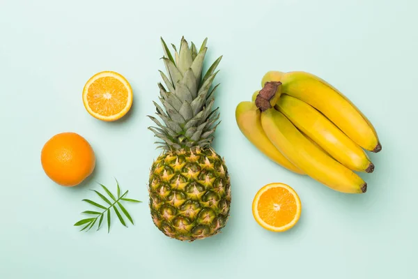 stock image Fresh tropical fruits on color background, top view