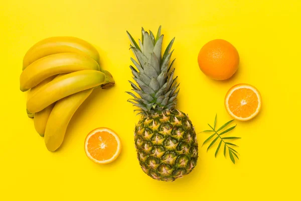 stock image Fresh tropical fruits on color background, top view