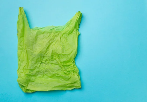Disposable plastic bag on color background, top view.