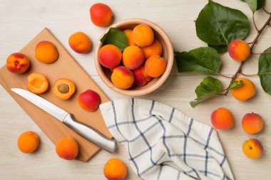 Composition with ripe apricots on wooden background, top view.
