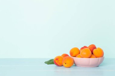Composition with ripe apricots on wooden table.