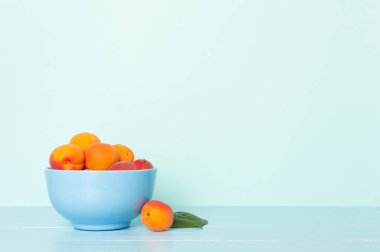 Composition with ripe apricots on wooden table.