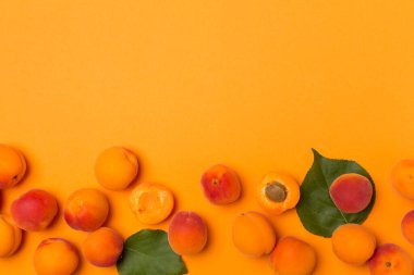 Flat lay with ripe ap.ricots on color background, top view.