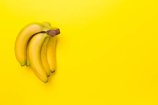 stock image Fresh bananas on color background, top view