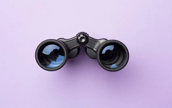 stock image Black binoculars on color background. Top view