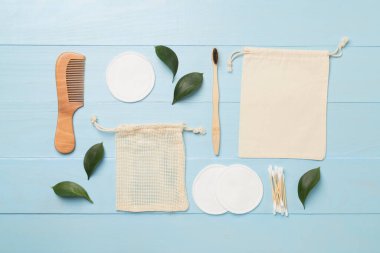 Flat lay with natural biodegradable accessories on wooden background, top view.