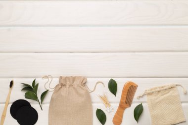 Flat lay with natural biodegradable accessories on wooden background, top view.