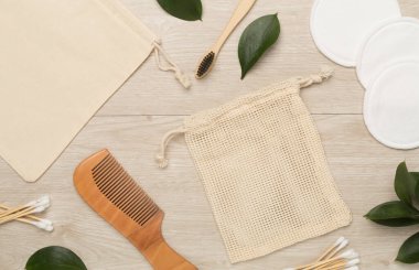 Flat lay with natural biodegradable accessories on wooden background, top view